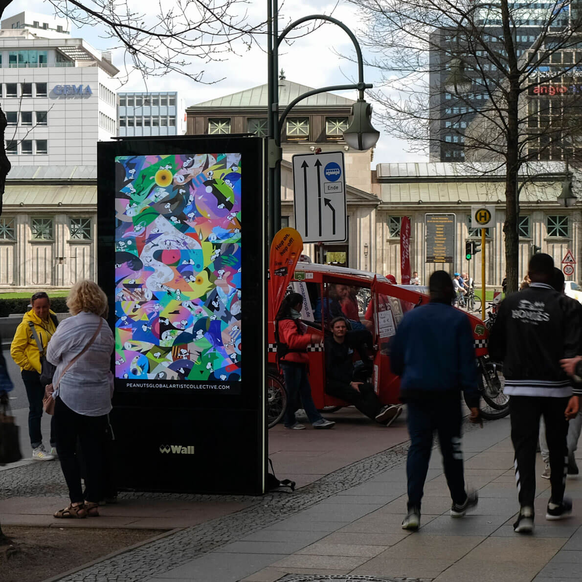 People walking on a busy sidewalk in a city.