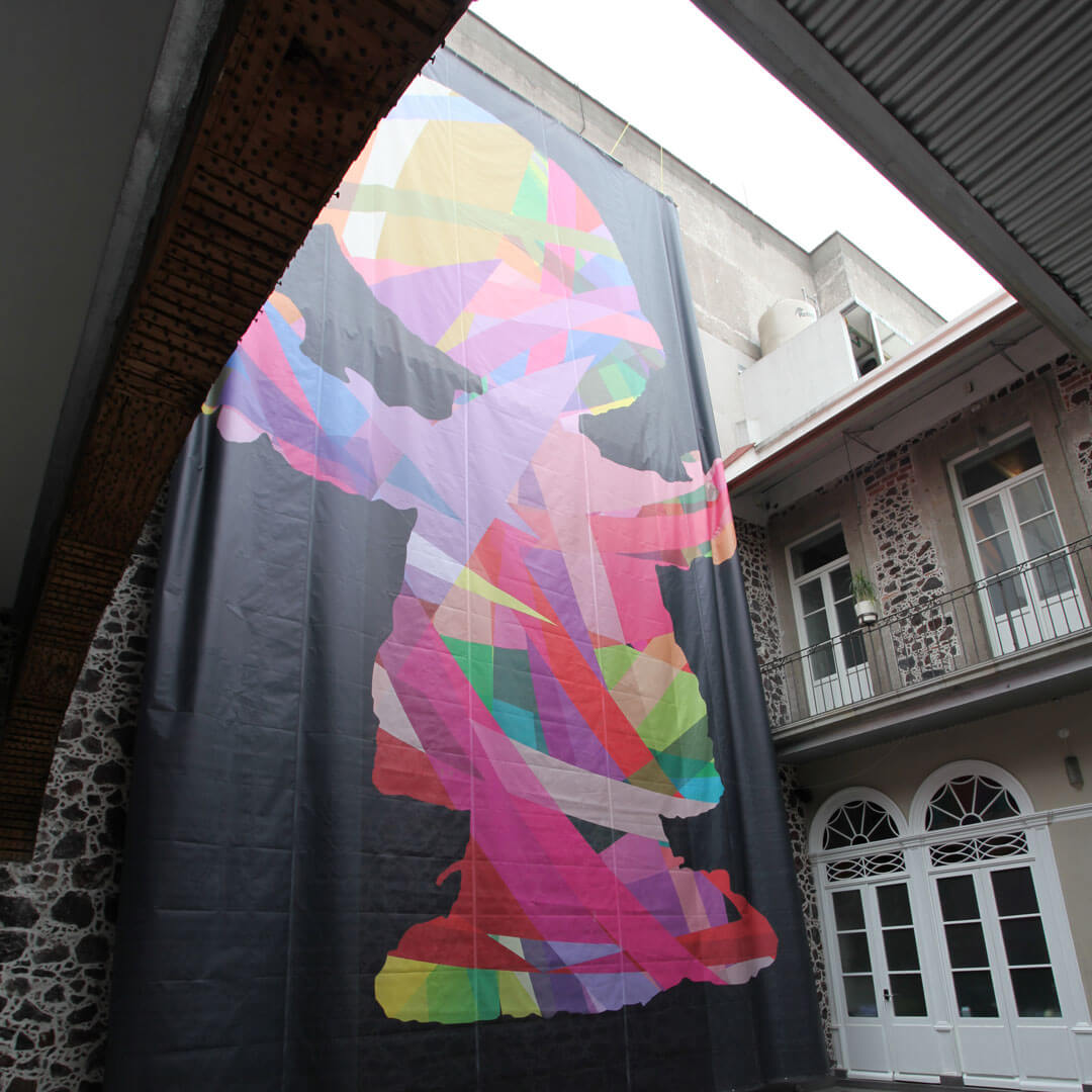 A large, colourful mural hanging from the wall of a building.