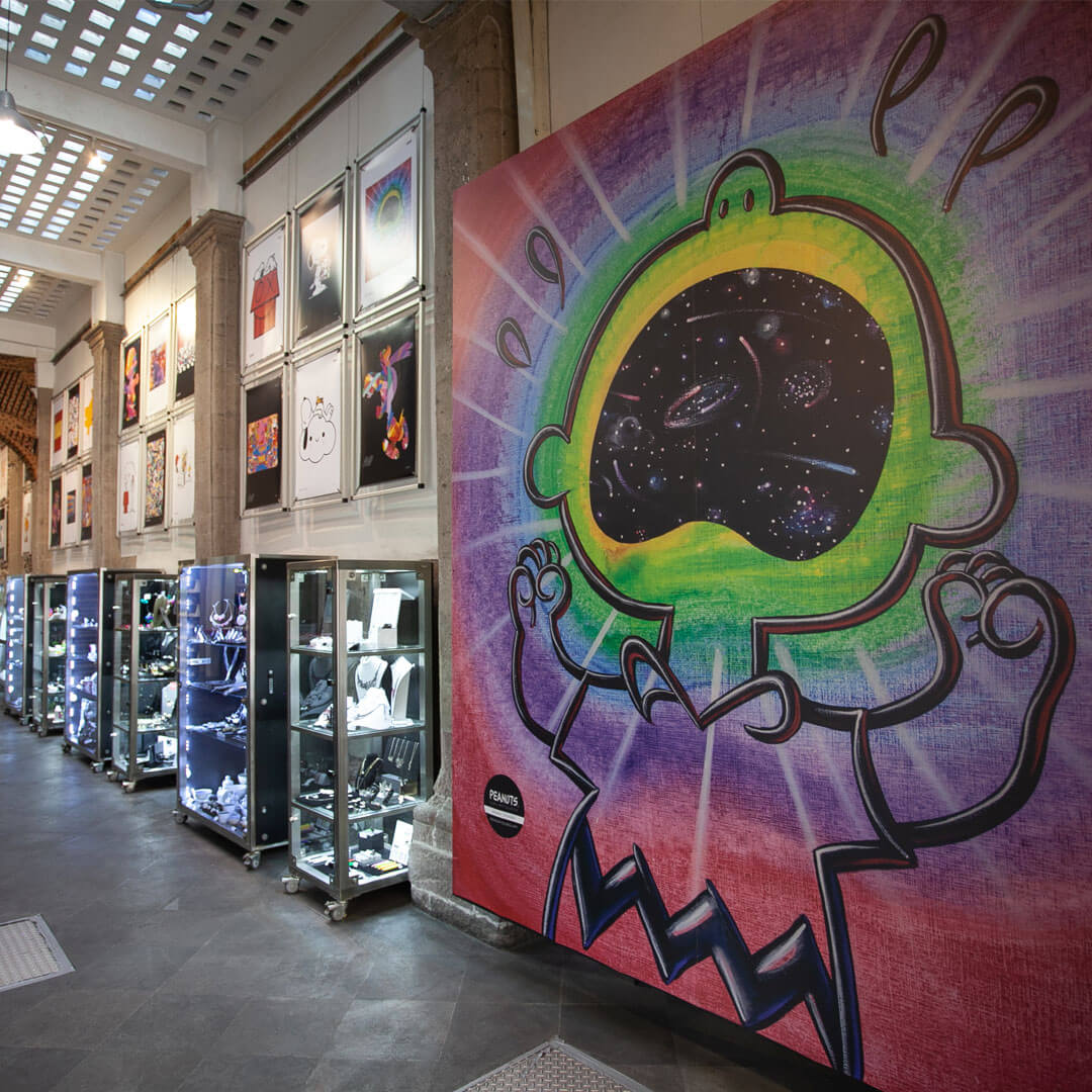 A large, colourful mural of a kid screaming inside of a store. 