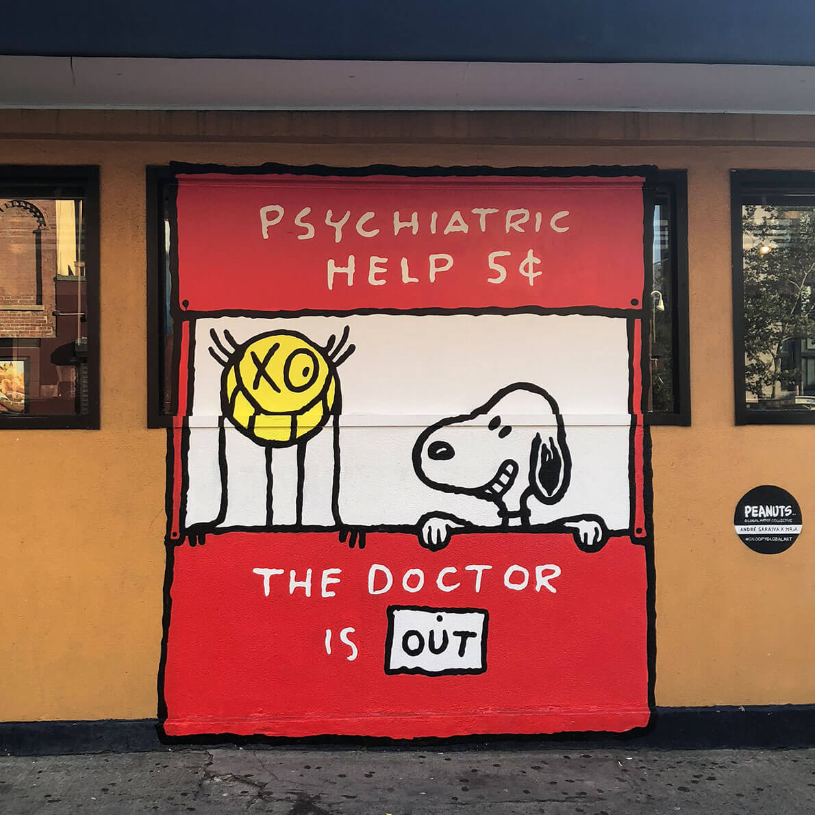 A mural of a red stand with a white dog and a yellow character standing behind it. 