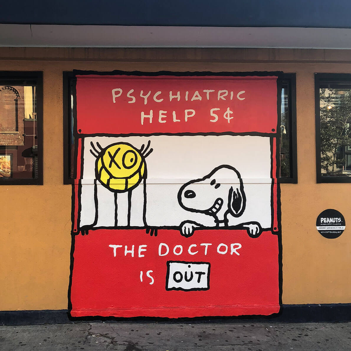 A mural of a red stand with a white dog and a yellow character standing behind it.