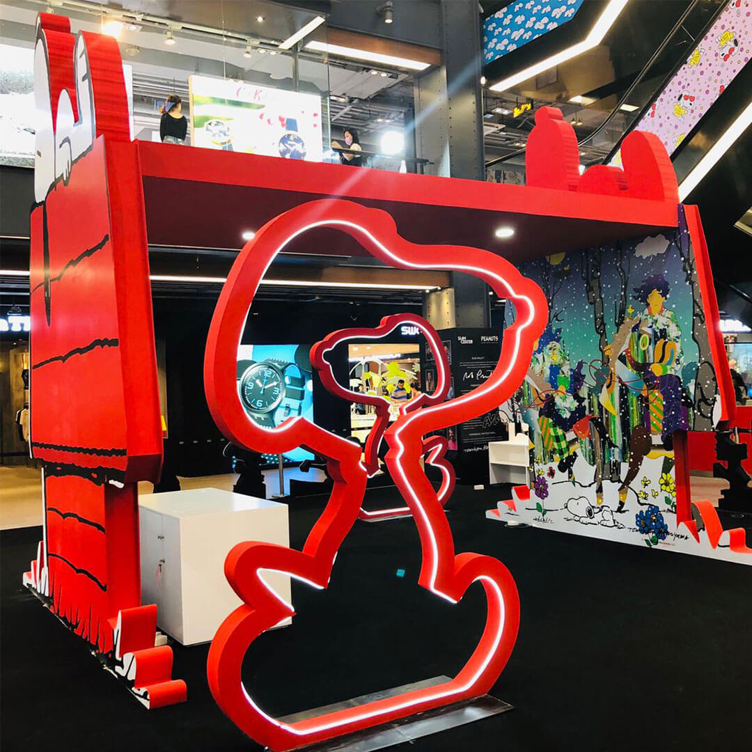 A giant art installation of a red dog house inside a shopping mall.