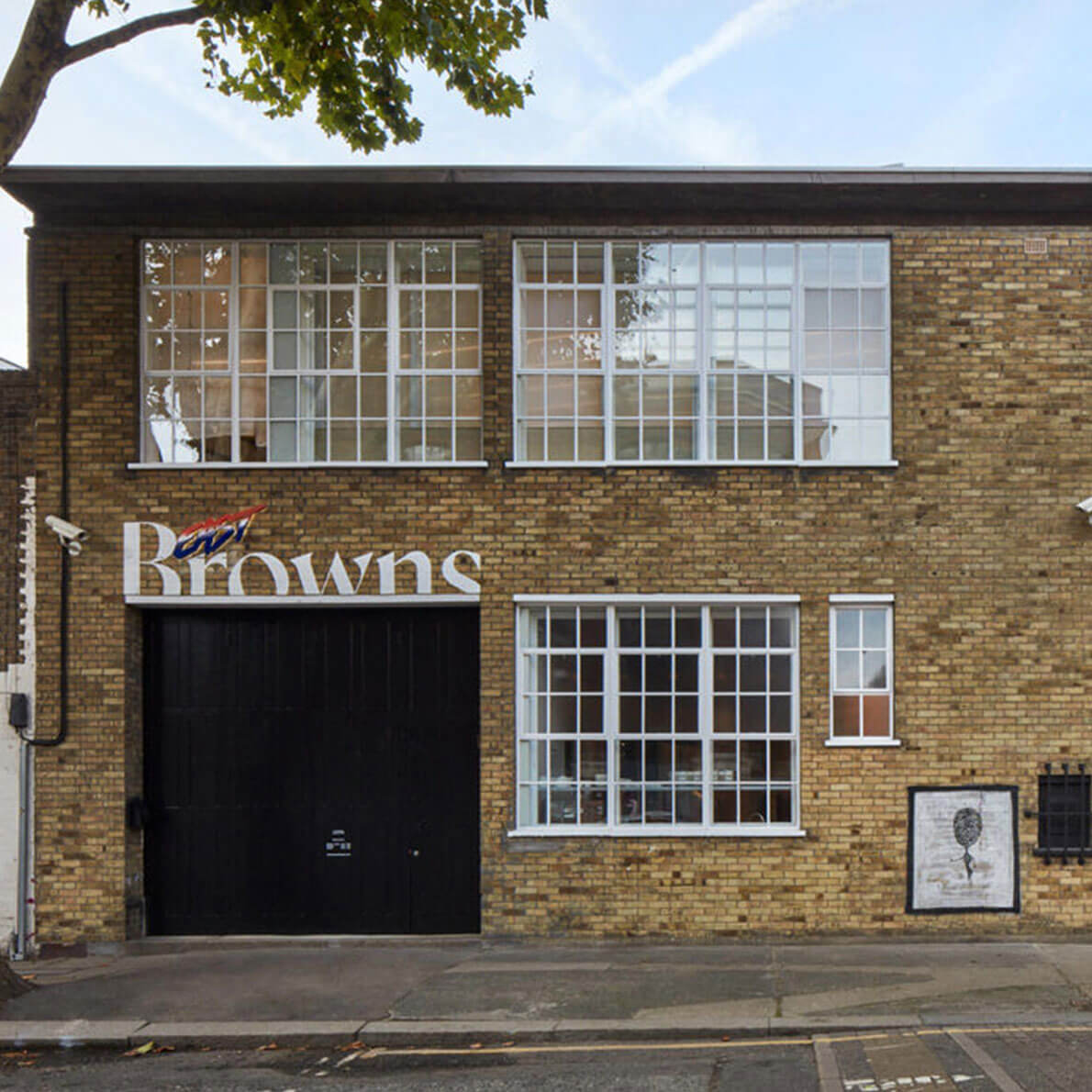 A low-rise brick building with glass windows.