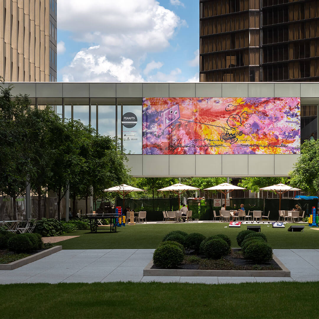 A large, colourful mural on glass building windows.