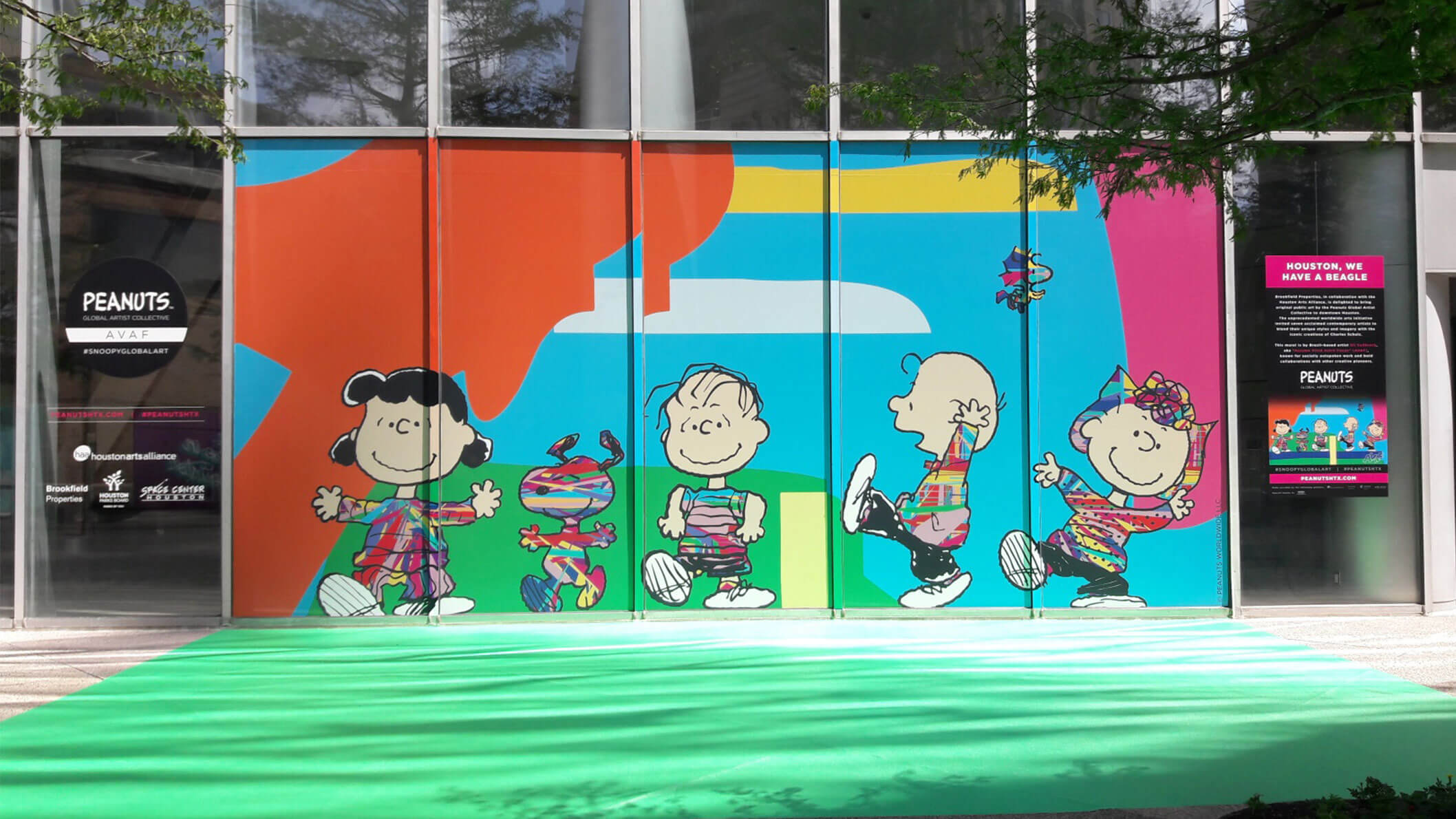 A large, colourful mural of cartoon characters on a glass window of a building.
