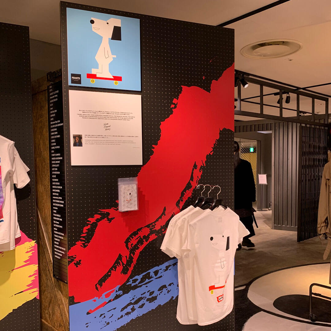 White t-shirts on display inside a store.