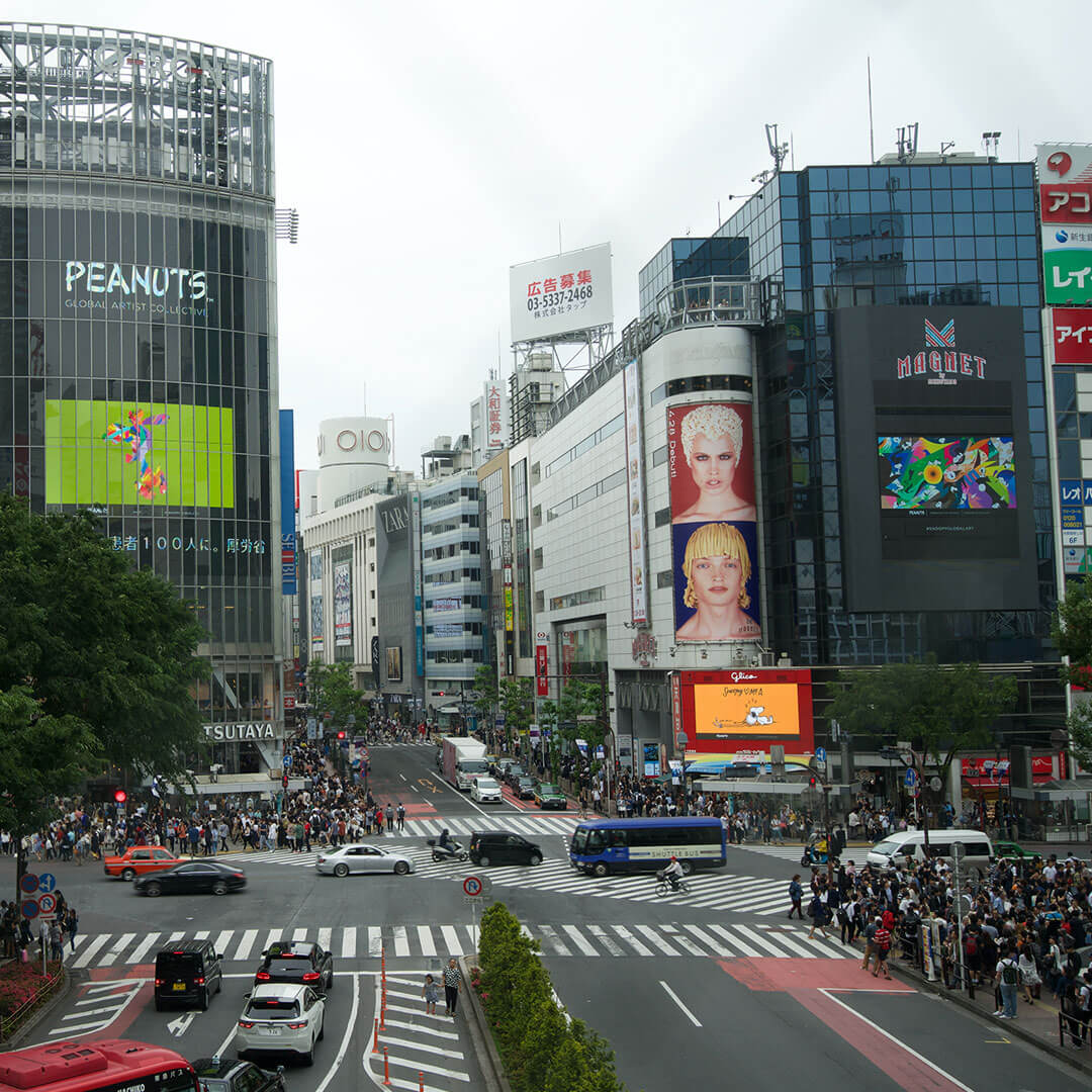 A busy street intersection with tall buildings.