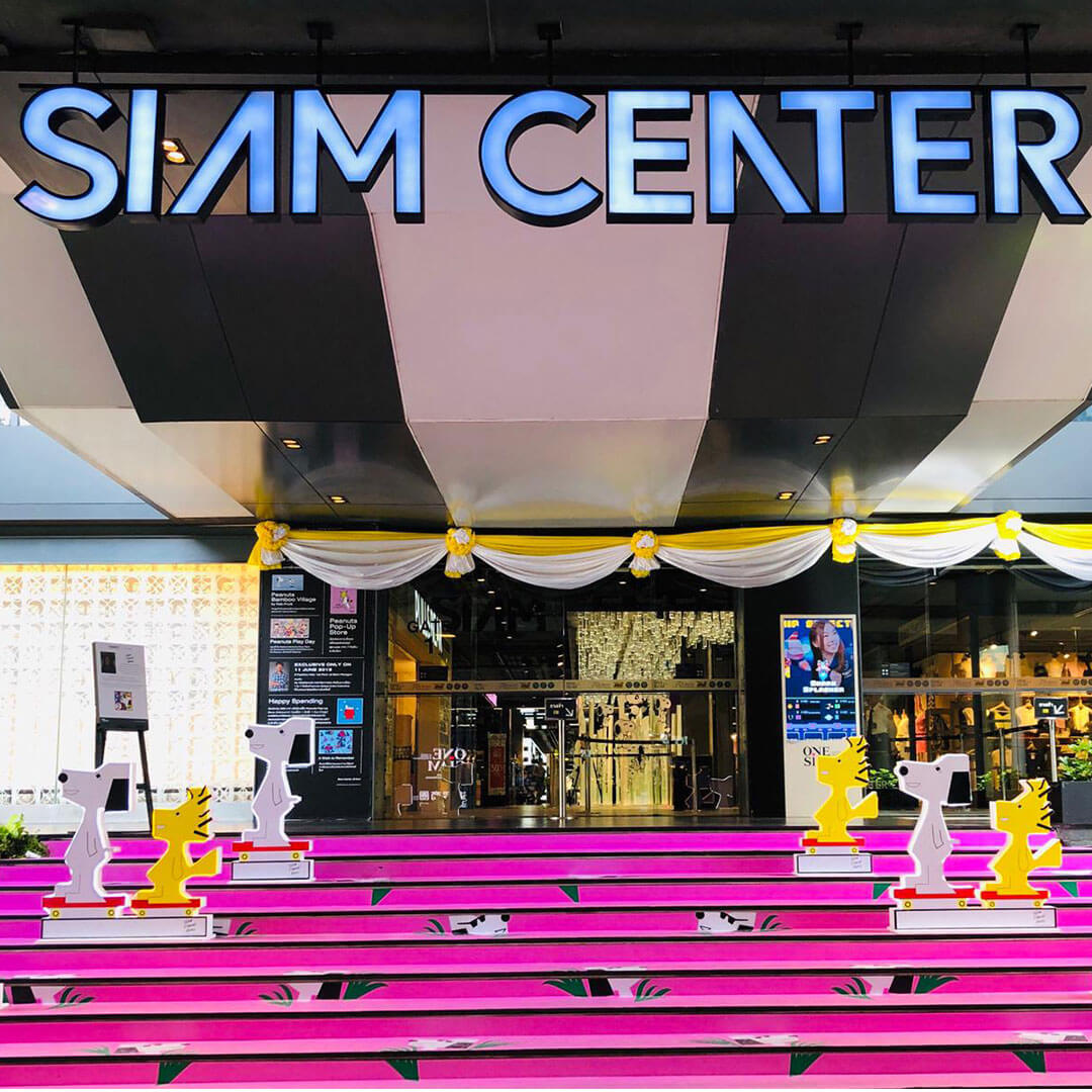 A building entrance with hot pink stairs.