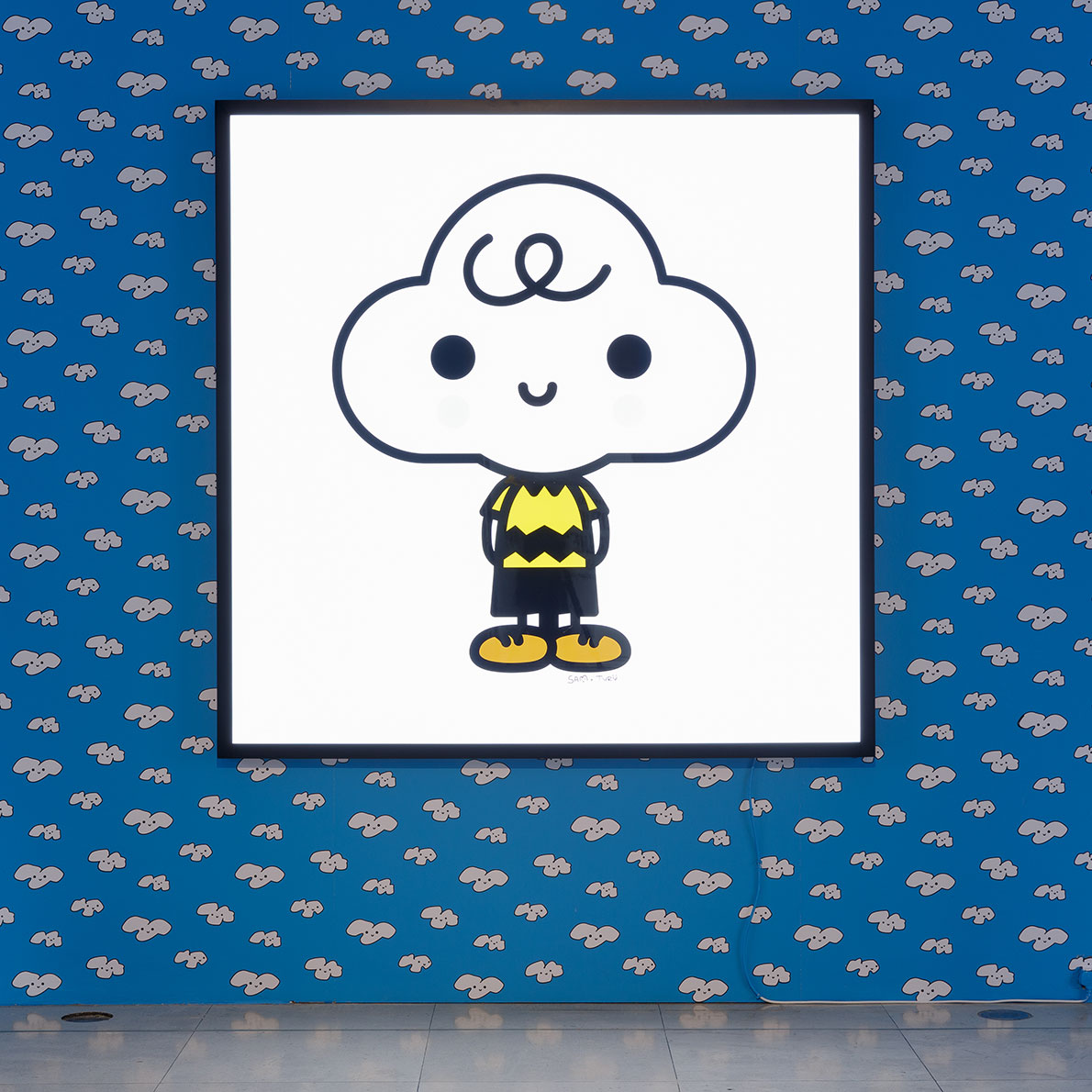 An illustration of a white cloud with a face hanging on a blue wall.
