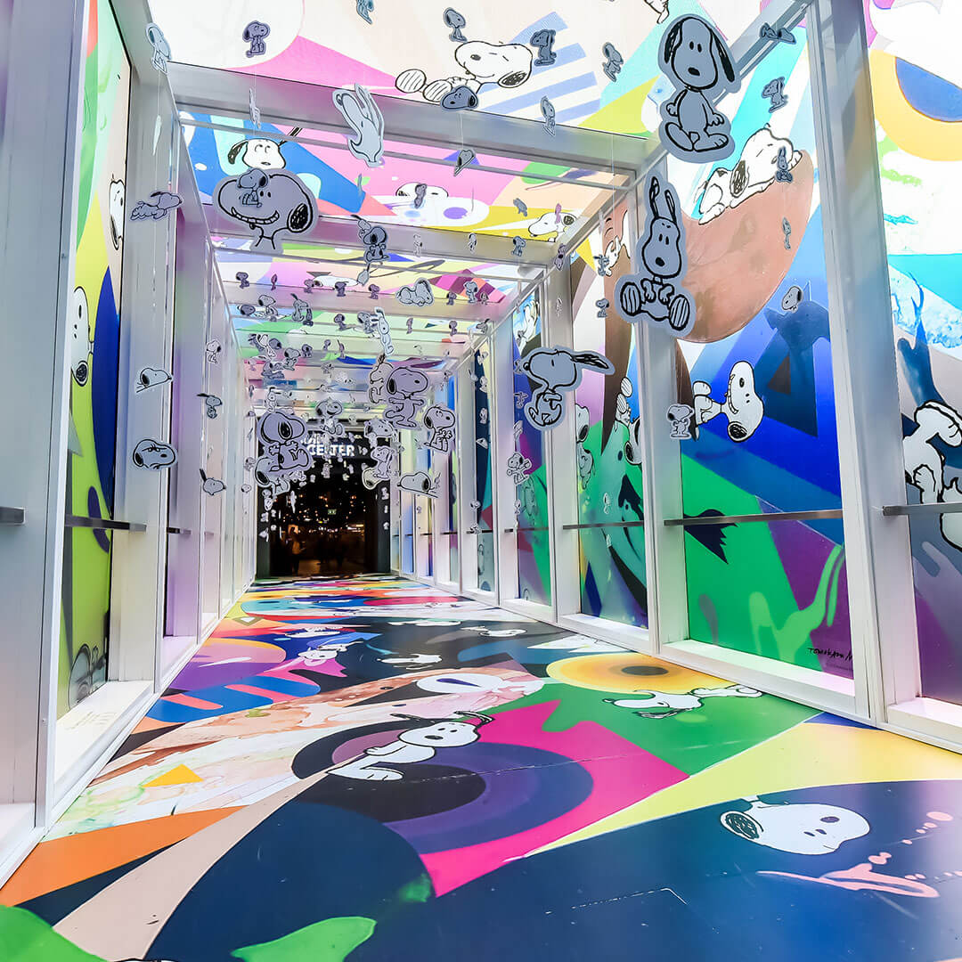 An indoor space with colourful wallpaper on the floor, ceiling and walls.